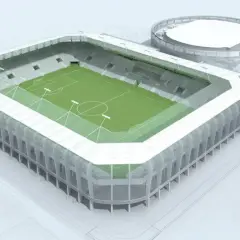 Nowoczesny stadion Radomiaka z zieloną murawą i wielopoziomowymi sektorami. Obok obiekt treningowy.