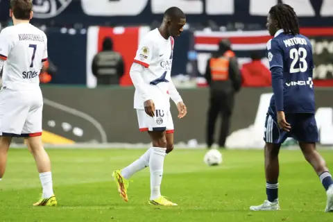 Piłkarz PSG, Ousmane Dembélé, schodzi z boiska, prawdopodobnie z powodu kontuzji. Obok niego inni zawodnicy.